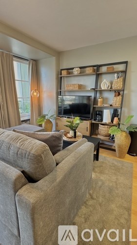 A balcony with a table and chairs overlooks a cityscape.