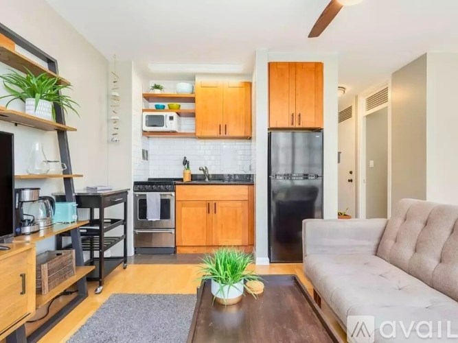 A modern kitchen with wooden cabinets and a refrigerator.