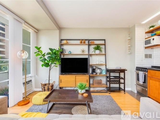 A living room with a wooden coffee table and a flat screen TV on a stand.