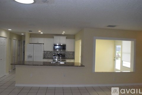 A kitchen with a counter and a sink.