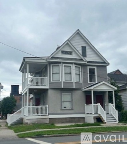 A two-story house with a grey and white exterior.