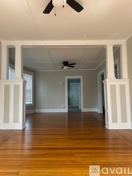 A room with wooden floors and white walls.