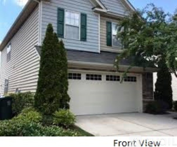 A house with a front view and a garage door.