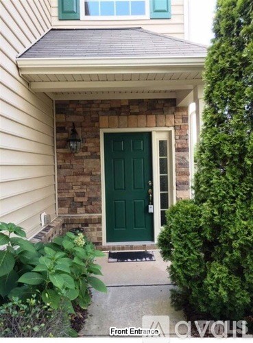 A house with a green door and a front entrance.
