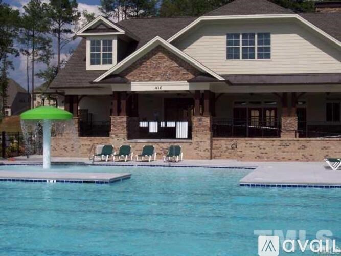 A house with a pool in front of it.