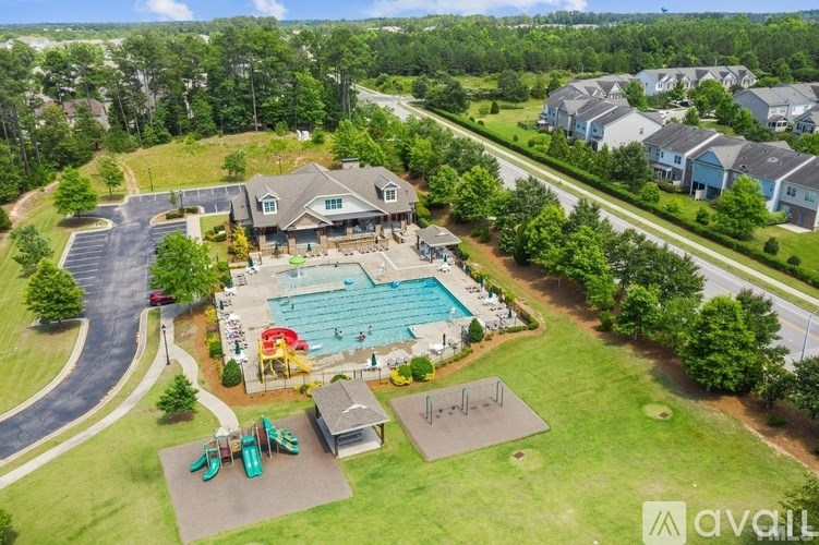A bird's eye view of a residential area with a swimming pool and a playground.