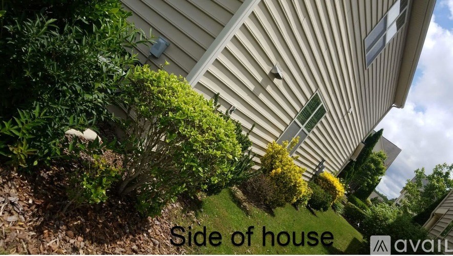 A house with a side view showing the house's siding and the roof.