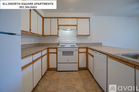 A kitchen with white appliances and wooden cabinets is available for rent.
