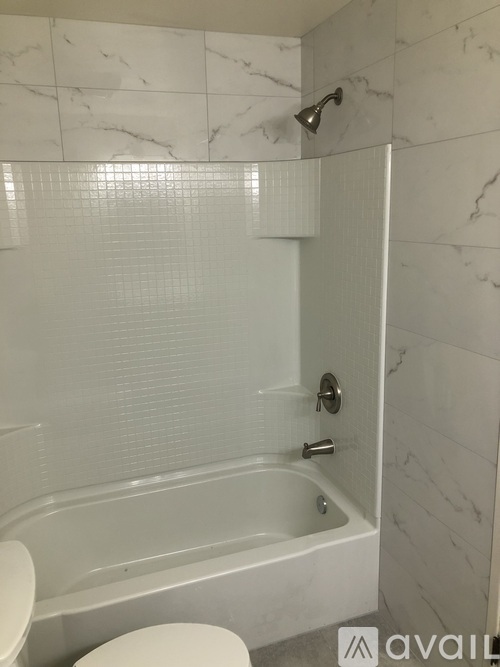 A white toilet sits next to a sink in a bathroom.