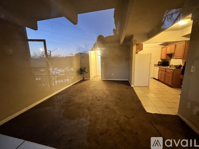 A living room with a view of the backyard through a window.