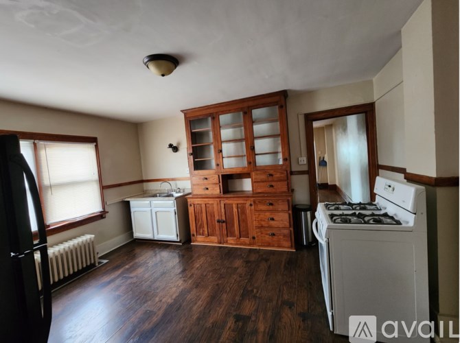 A kitchen with wooden floors and furniture.