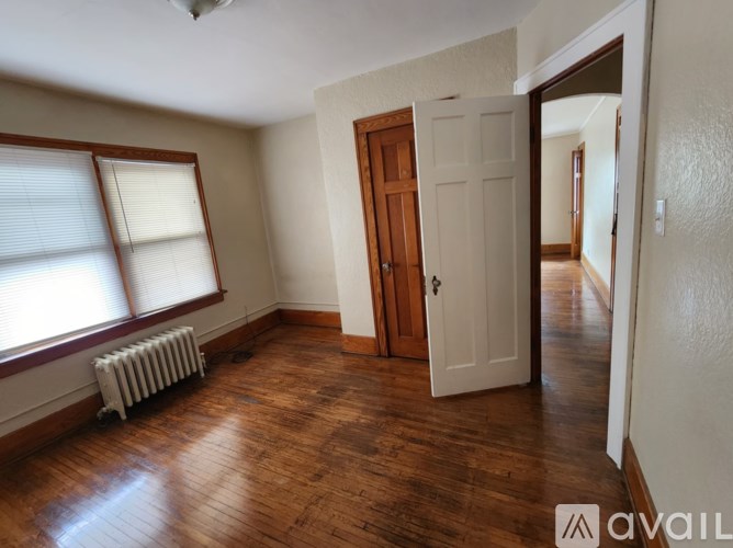A room with wooden floors and a white door.