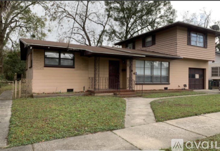 A house with a brown roof and a brown door is for sale.