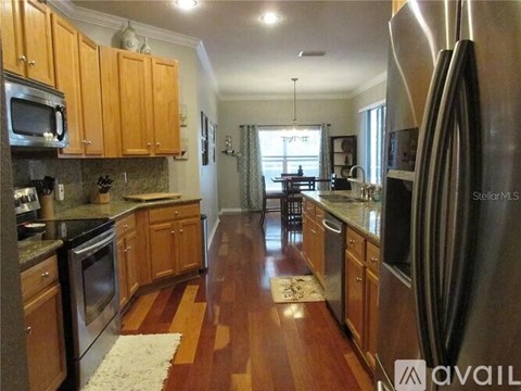 A kitchen with wooden cabinets and stainless steel appliances.
