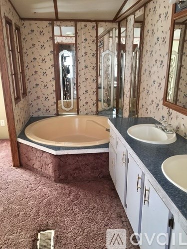 A bathroom with a bathtub, sink, and mirror.