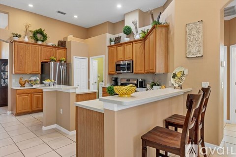 A kitchen with wooden cabinets and a white countertop.