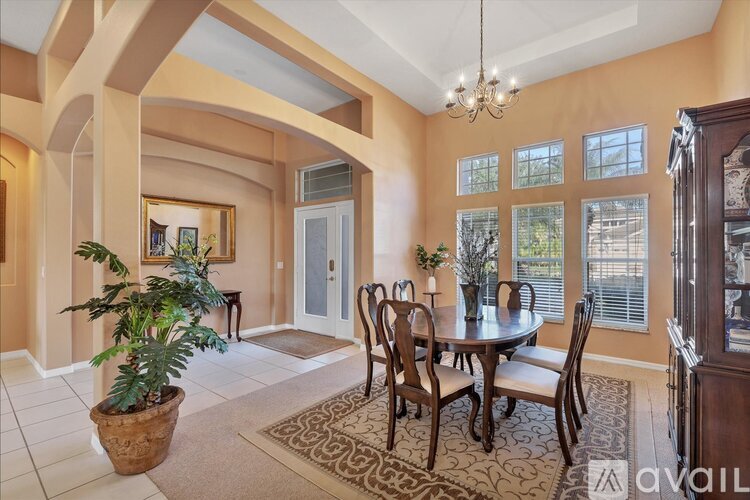 A dining room with a table set for four.