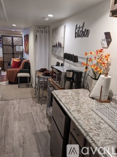 A kitchen area with a counter and a sign that says "Pantry".