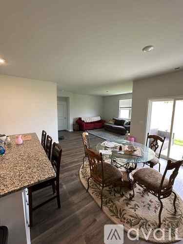 A dining room with a table set for four.