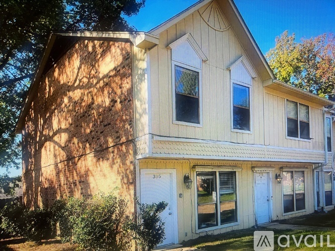 A house with a white door and windows is for sale.