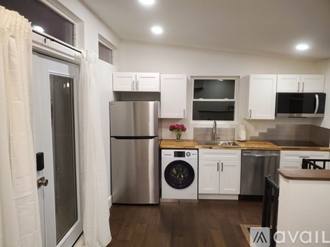 A kitchen with white cabinets and stainless steel appliances.
