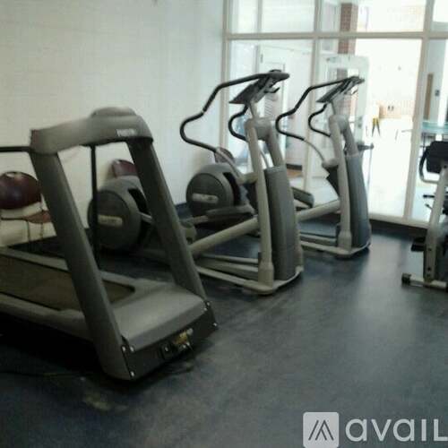A gym with treadmills and elliptical machines.