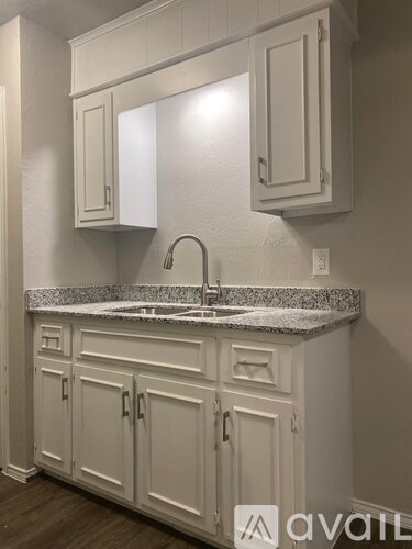 A bathroom with a sink and cabinets.