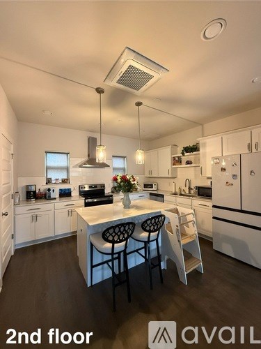 A kitchen with a table and chairs in the middle of the room.