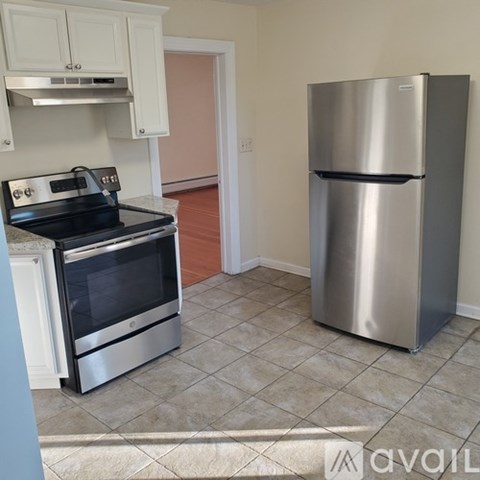 A kitchen with a stove and a refrigerator.