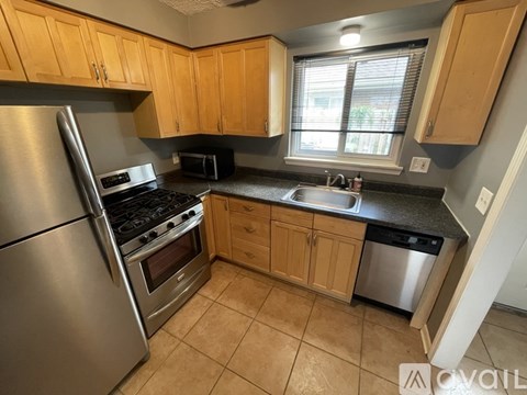 A kitchen with wooden cabinets and stainless steel appliances.