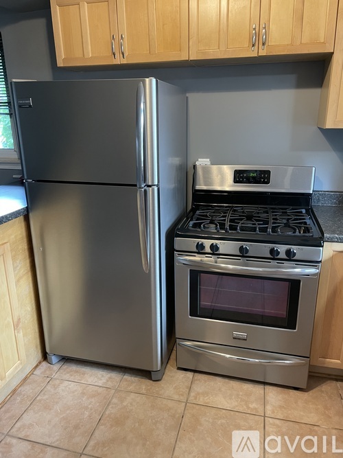 A kitchen with a stainless steel refrigerator and oven.