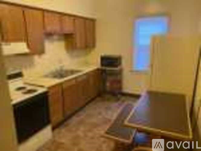 A kitchen with wooden cabinets and a black oven.