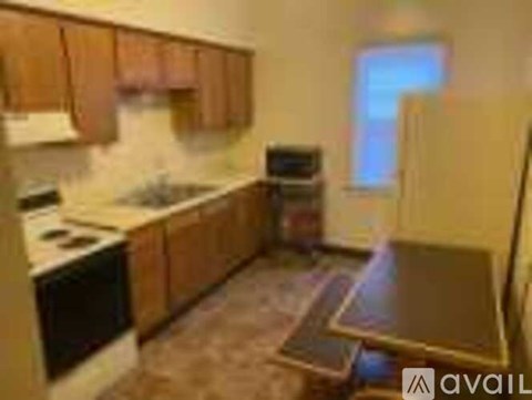 A kitchen with wooden cabinets and a black oven.