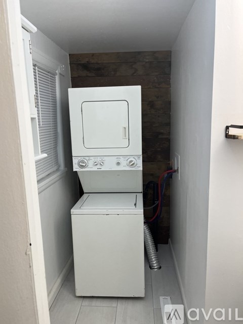A white dishwasher is installed in a narrow kitchen space.