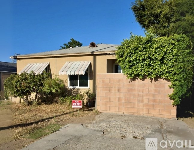 A house with a red sign that says "Rent" in front of it.