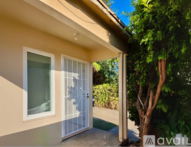 A house with a white door and window is available for rent.