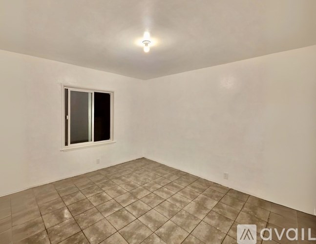 A room with a tiled floor and a window.