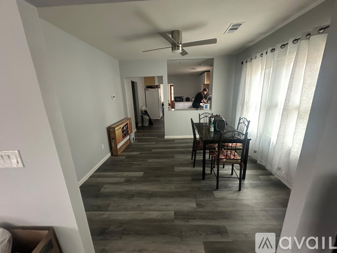 A room with a window and wooden flooring.