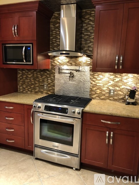A kitchen with a stove top oven and a microwave above it.