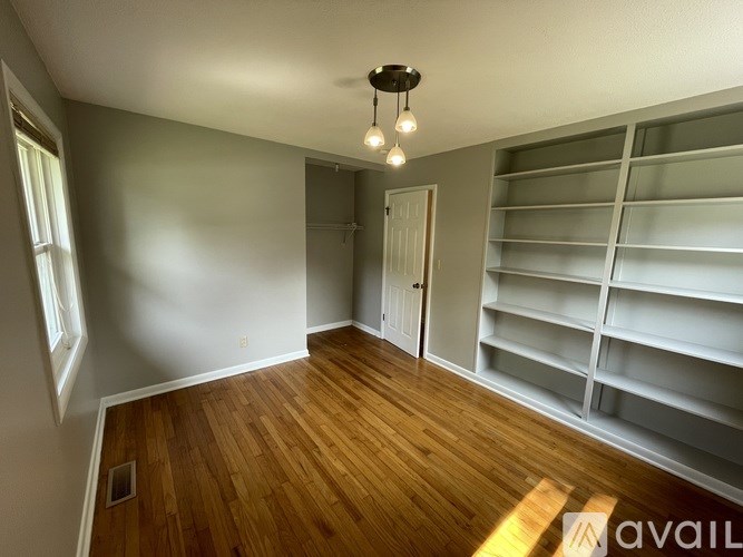 A room with wooden floors and a white door.