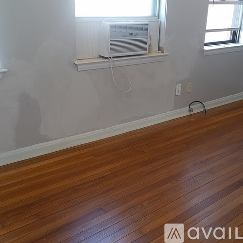 A room with wooden floors and a window.