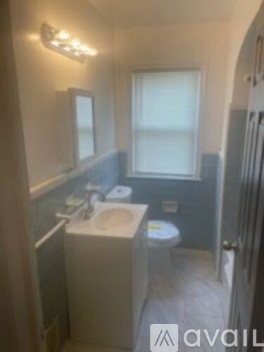 A bathroom with a sink, mirror, and toilet.