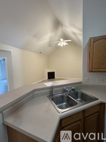 A kitchen with a sink and a fan.