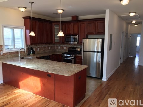 A kitchen with wooden cabinets and a granite countertop.