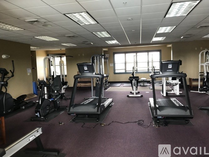A gym with treadmills, elliptical machines, and other cardio equipment.
