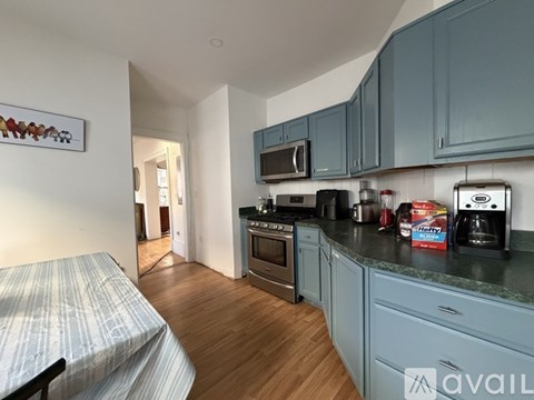 A kitchen with wooden cabinets and a granite countertop.