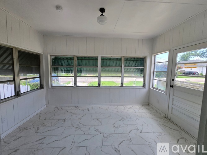 A room with a marble floor and a ceiling fan.