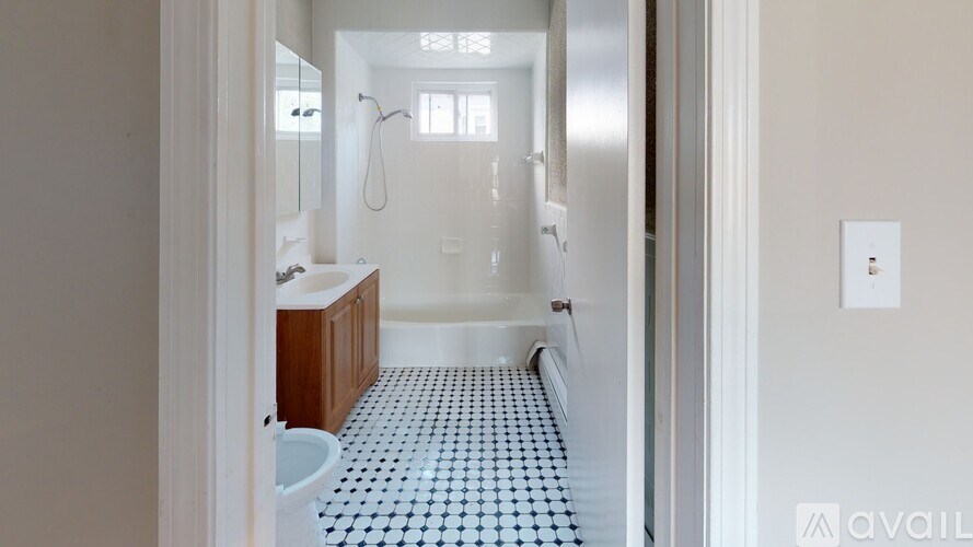 A bathroom with a toilet, sink, and shower.