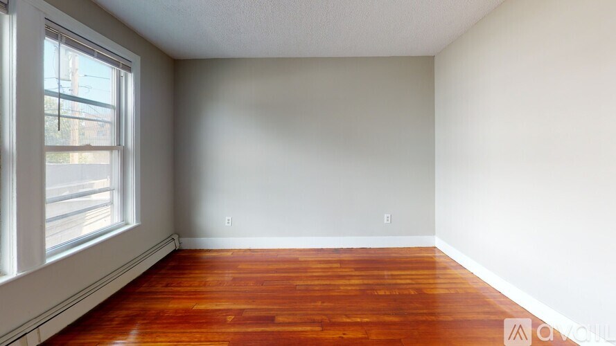 A room with wooden floors and a window.