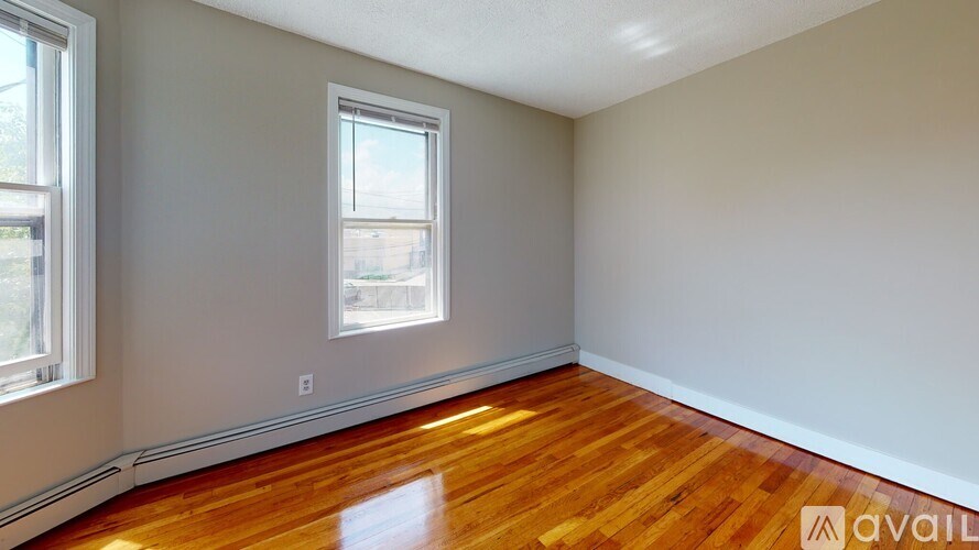 A room with wooden floors and a window.